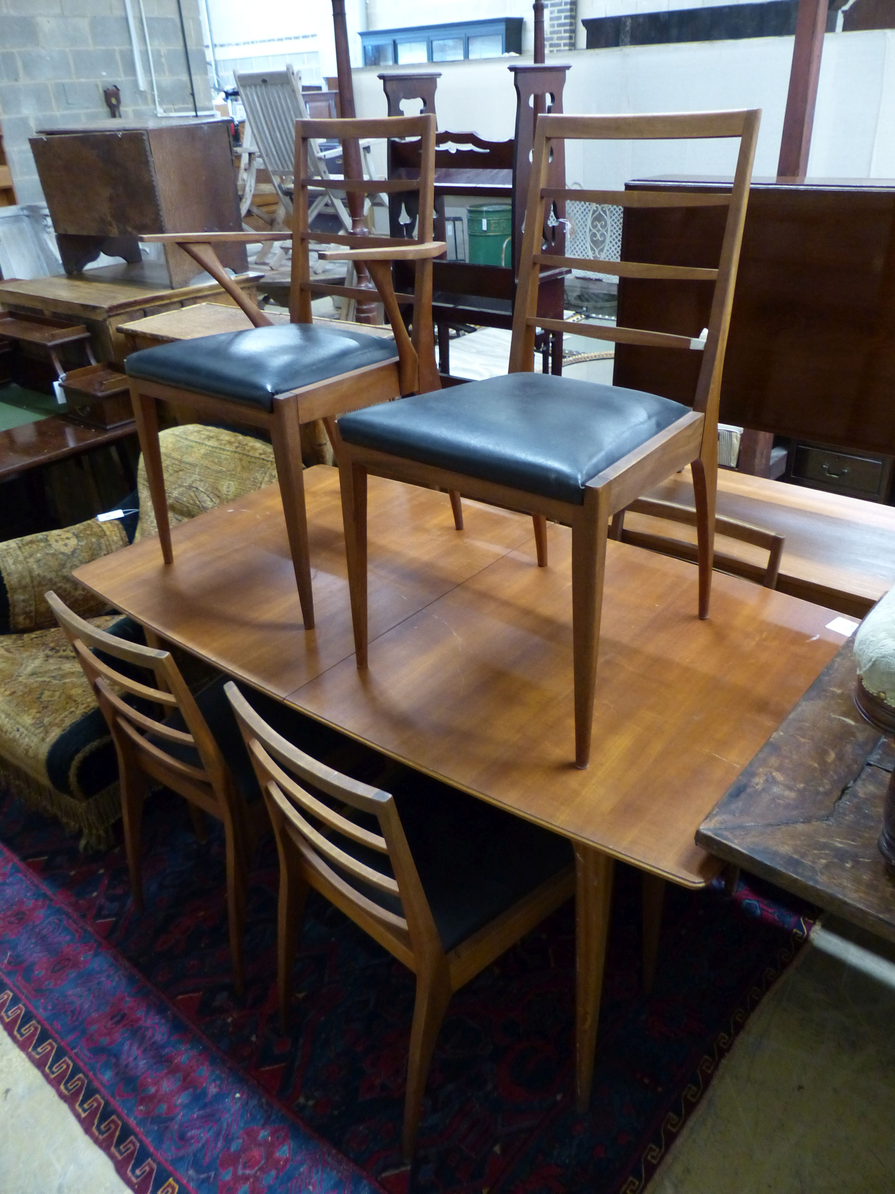 A mid century H McIntosh, extending teak dining suite comprising of table, six chairs and sideboard